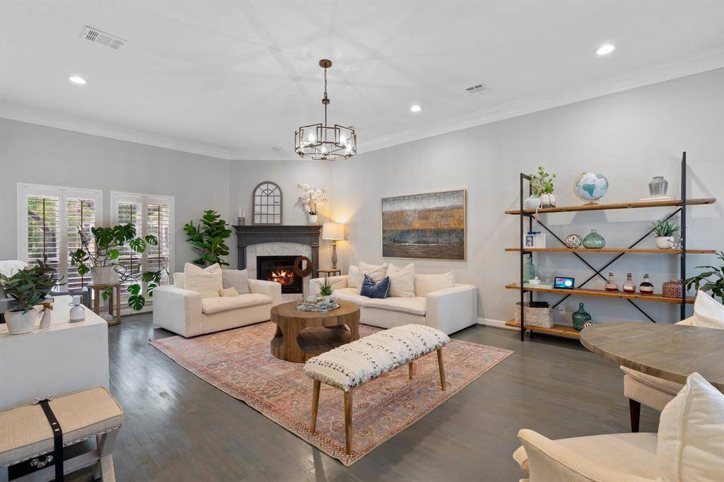 Large living room with beautiful natural light, gas log fireplace and high ceilings.