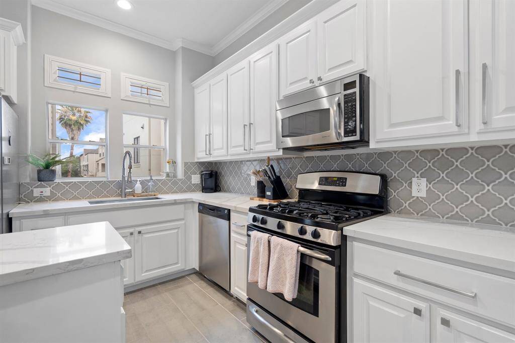 Beautiful kitchen with natural light, plenty of storage and counterspace.