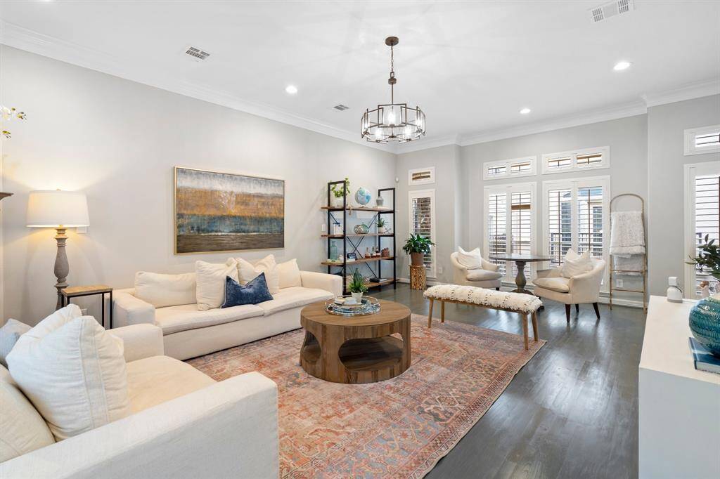 Another view of the living room showing how large the space is and the abundance of natural light.