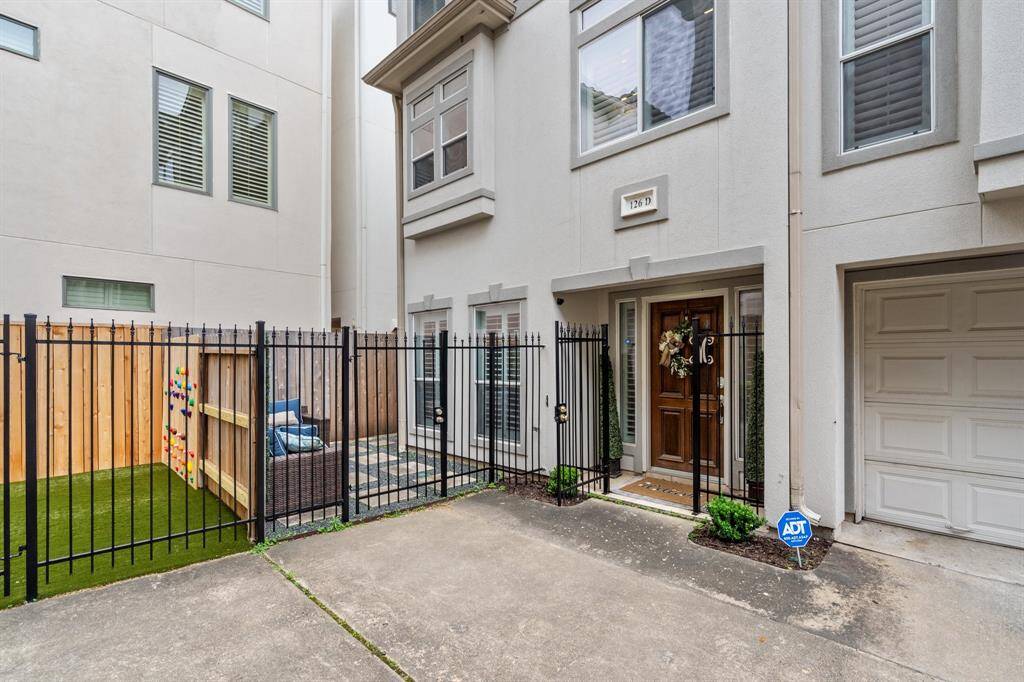 Welcome home! Gated front door and "front yard" area. Two car garage large enough for a truck and SUV and garage door will close with truck inside!