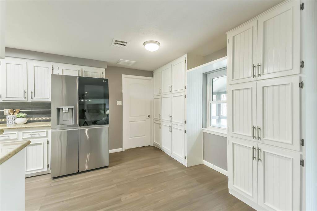 You'll love the amount of cabinet space/pantry space that you have in this kitchen. And, the VERY upscale fridge stays!