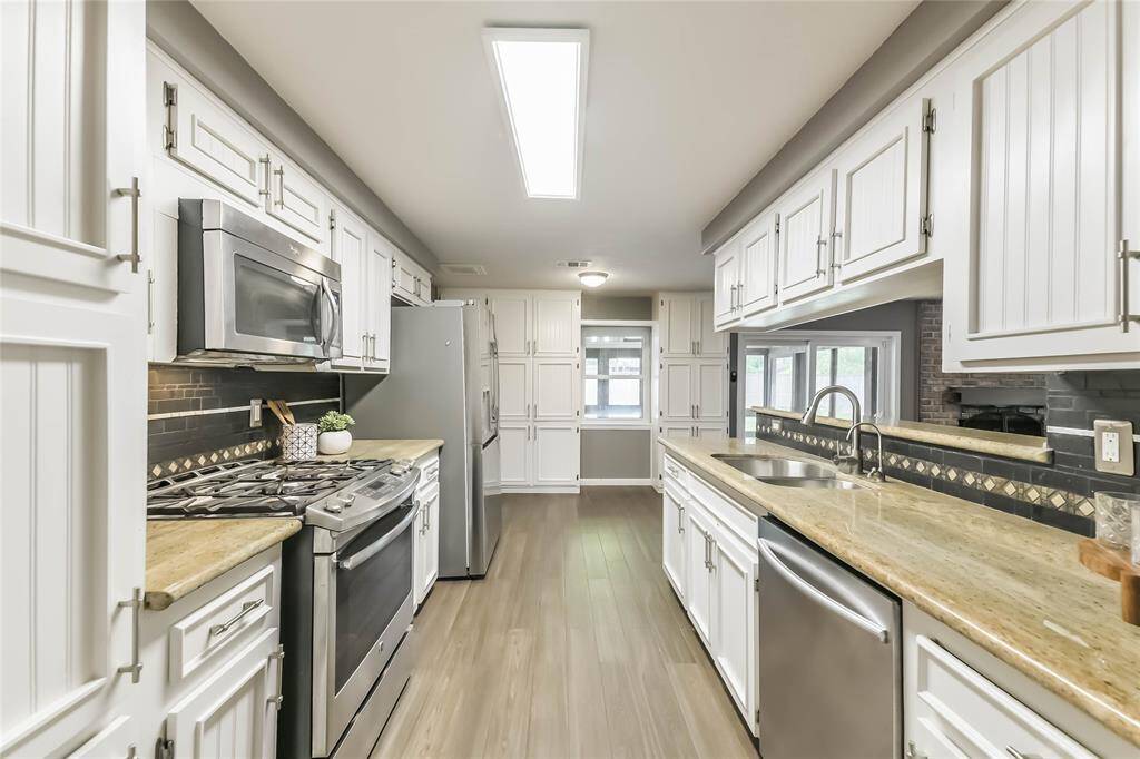A view of the kitchen facing the other way. Note the wall of cabinets at the far end!