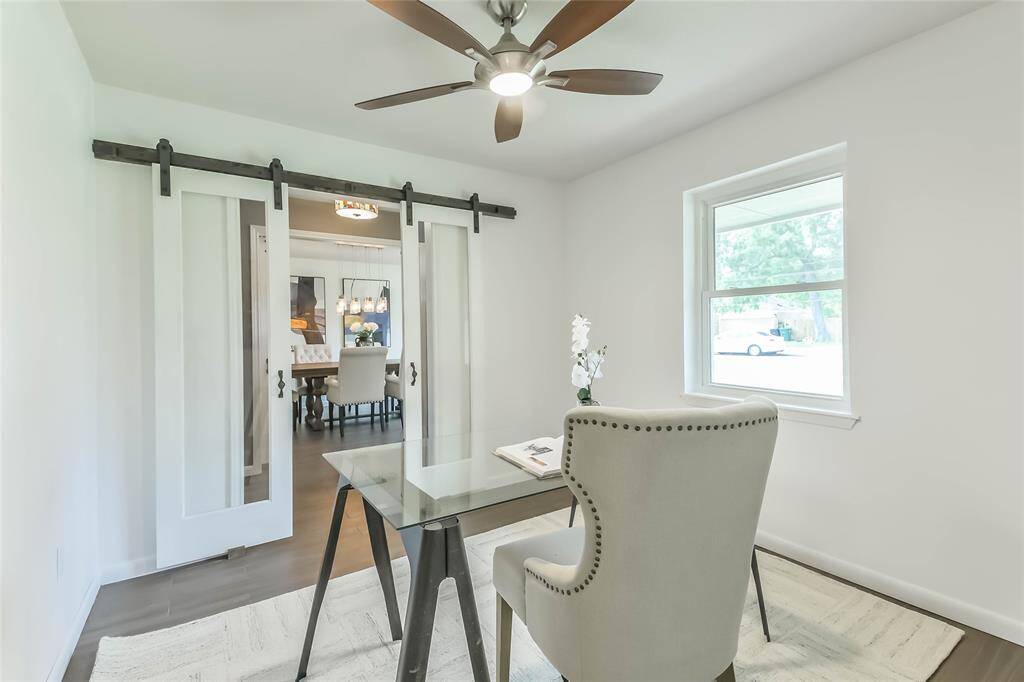 The office is across the entryway from the dining room. Both can be closed off with barn doors.