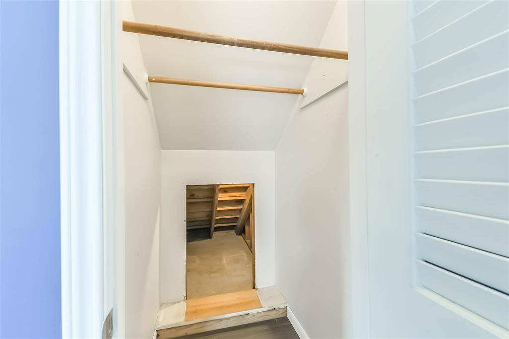 This is the second primary closet. Back to back bars are a great way to switch up your clothing for the different seasons. In the back of this closet, there is additional storage under the stairs.