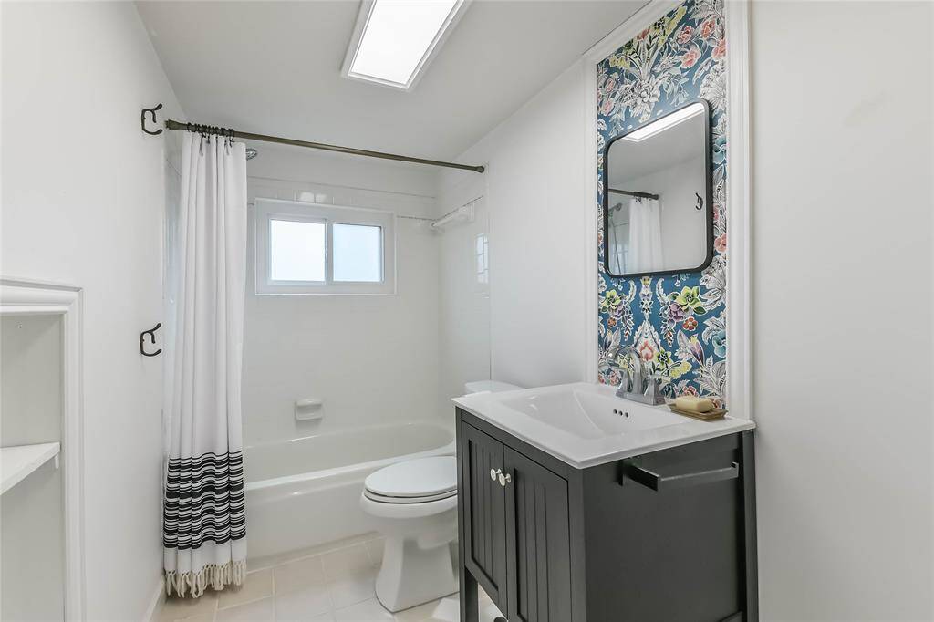 This is the hall bath upstairs. Sparkling clean! Updated farmhouse style! If you look to the left you'll see the storage nook.
