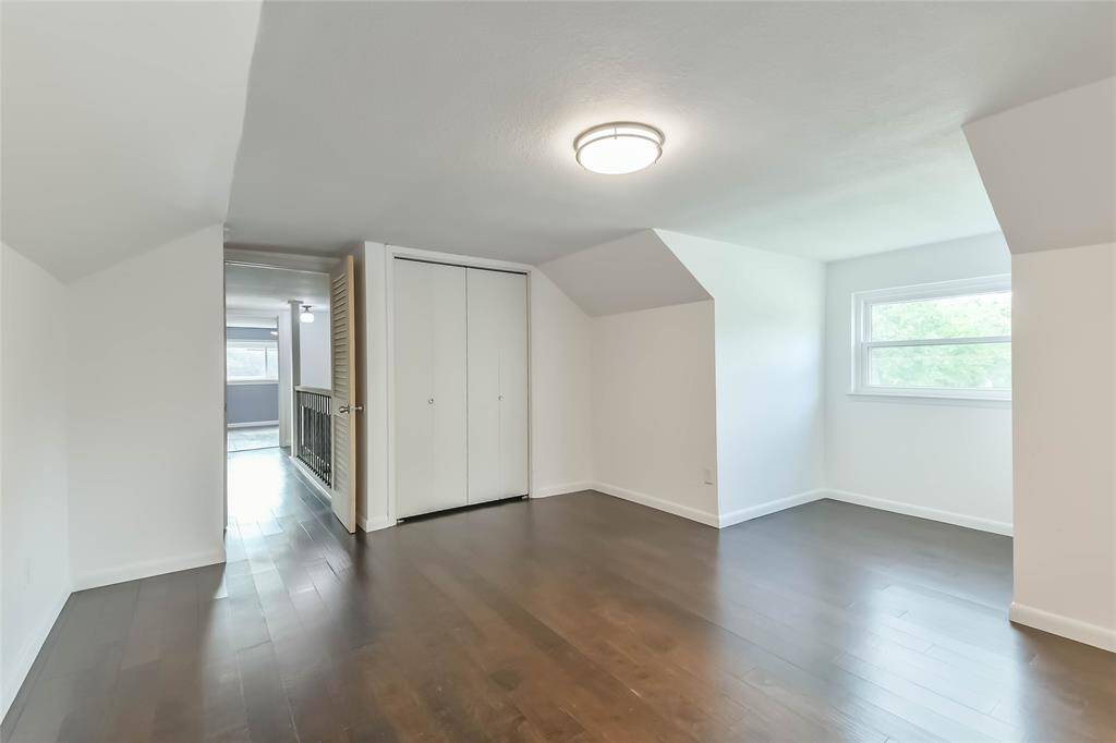 This is the upstairs third bedroom looking towards the hall and stairs. Lots of natural light!