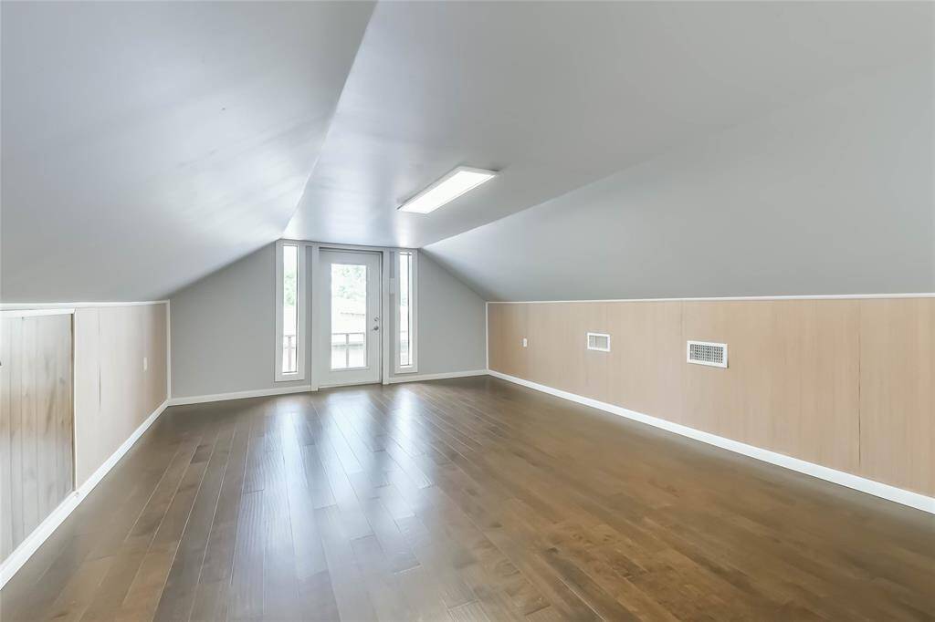 This is the gameroom or second living room. The doors lead to a small balcony and stairs to the side yard.
