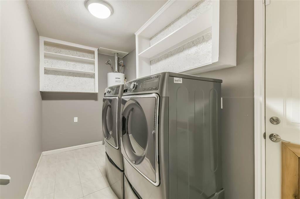 The laundry room is IN the house, just off the kitchen. The Washer and Dryer STAY!!! Did I mention that all you have to do is move in?