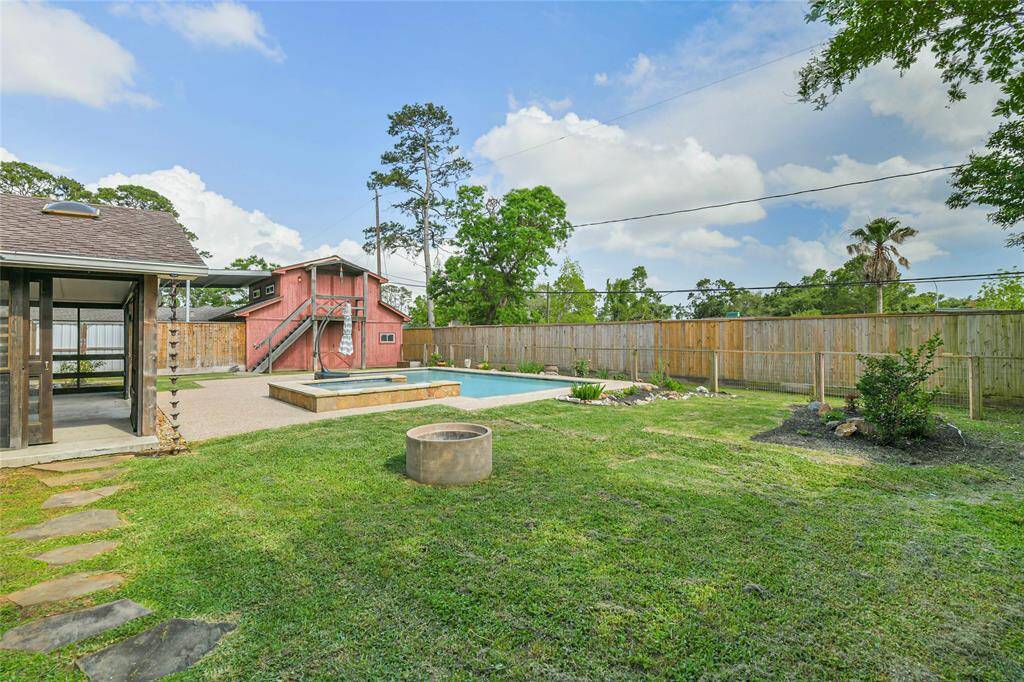 View towards the barn in the backyard. Fire pit! And not shown, a little gardening shed.