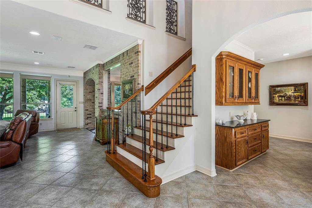 The elegant staircase with wrought iron details adds a touch of sophistication.