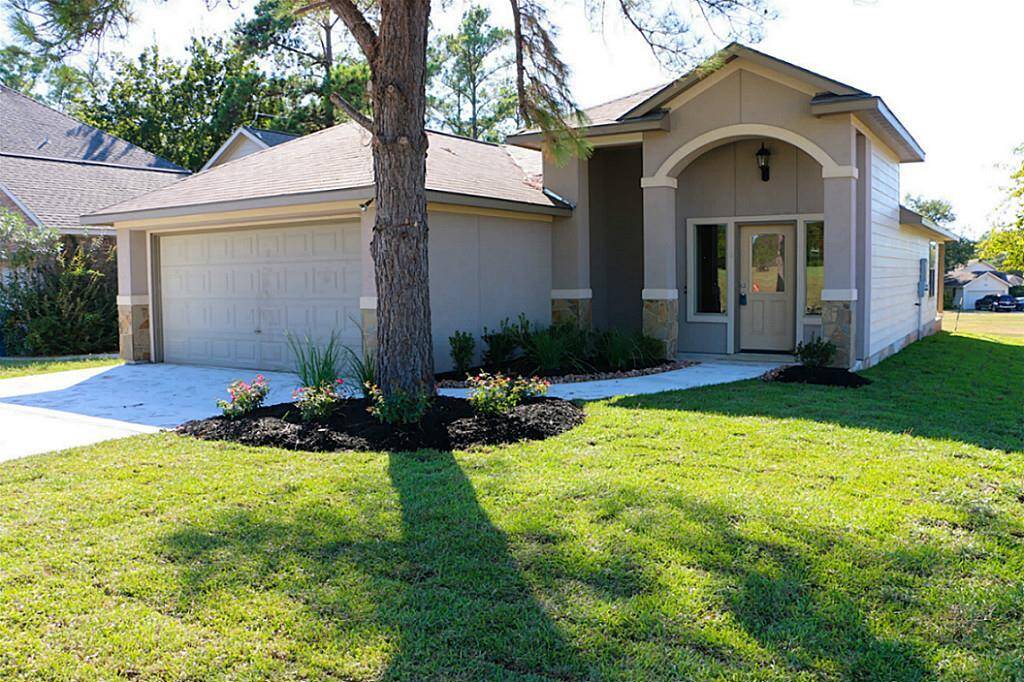 Covered front porch area with landscaped yard.