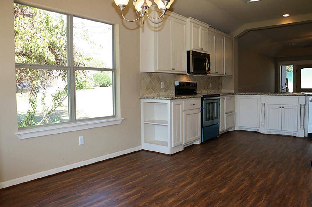 Granite counter tops with tile back splash. Lots of cabinet space.