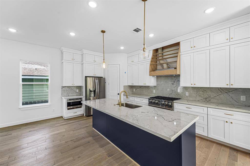 Floor to ceiling cabinets, and plenty of counter space. (Over range hood cover to be installed very soon)