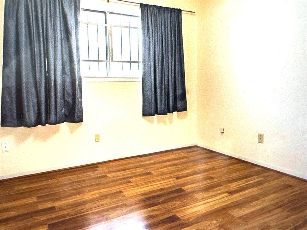 Secondary bedroom with wood floors