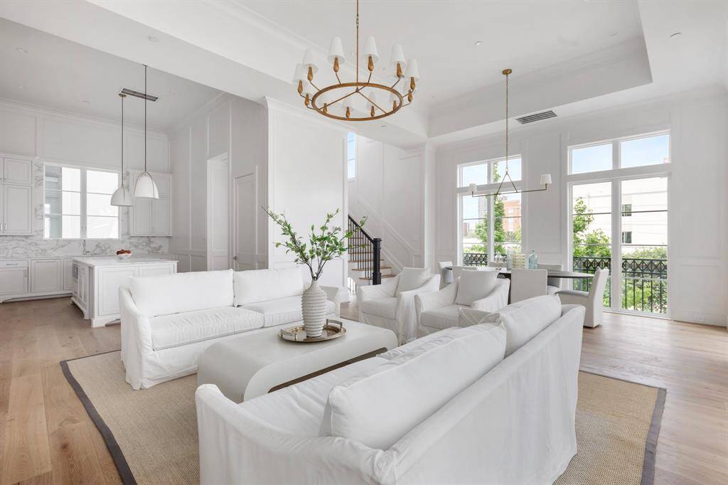 The natural light drawis attention to layered architectural trim and designer wood paneling that define the space with elegance.