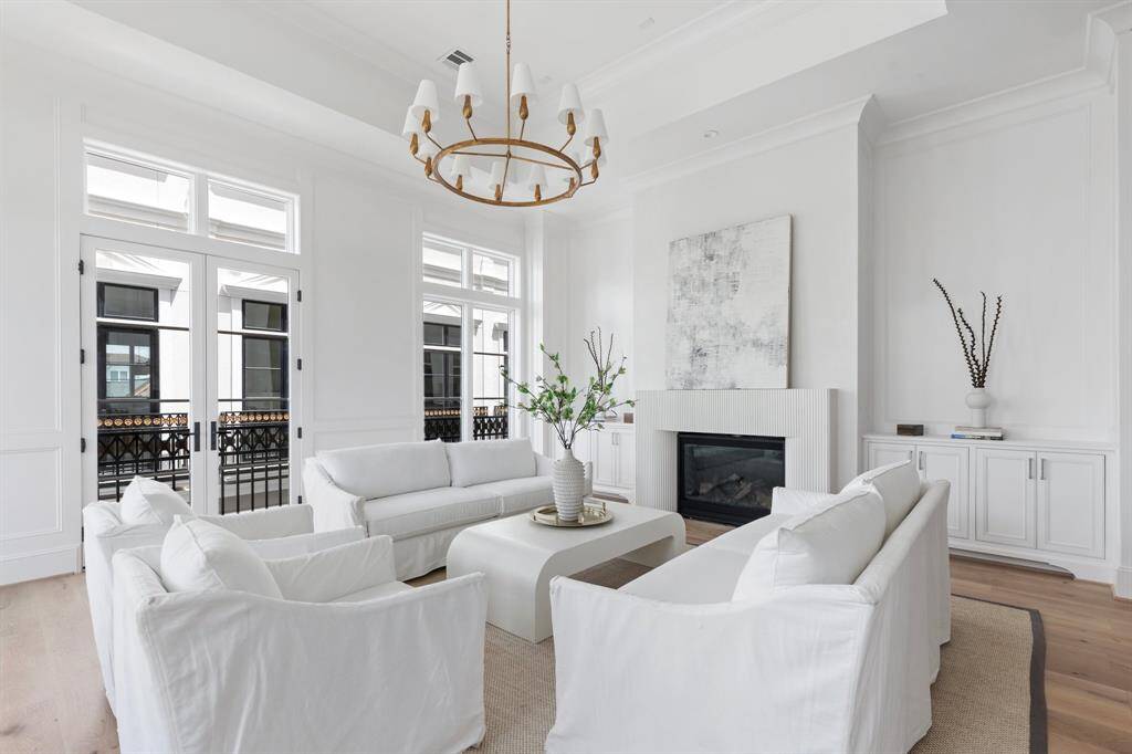 With soaring ceilings, tall windows, and intricate wall paneling, this living space evokes the elegance of a Parisian apartment—refined, light-filled, and quietly luxurious.