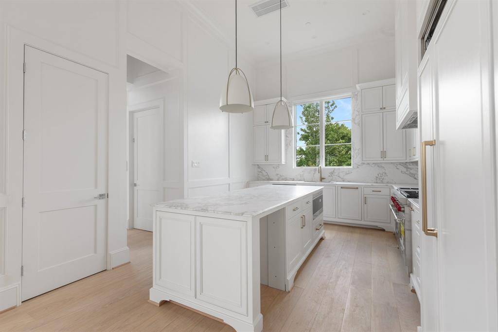 1323 Peden benefits from green views out the kitchen window.
