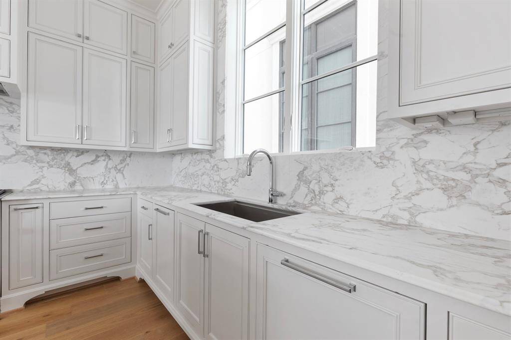 High-end luxury details include such features as imported marble countertops and backsplash with under-cabinet lighting + hidden outlet strips to maintain the clean and modern look.