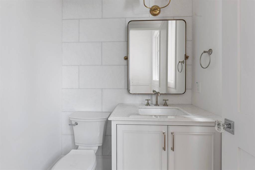 Tucked away on a private landing down the staircase, the second floor half bath features gorgeous finishings and privacy.