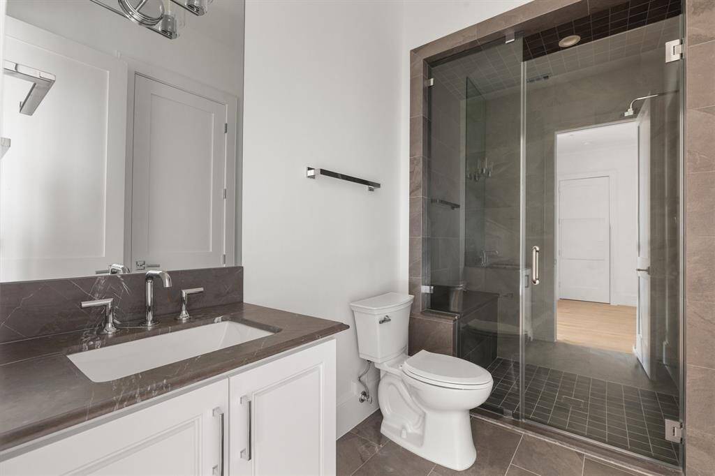 Shared between the bedroom and game room, this bathroom offers dual access points from both spaces.