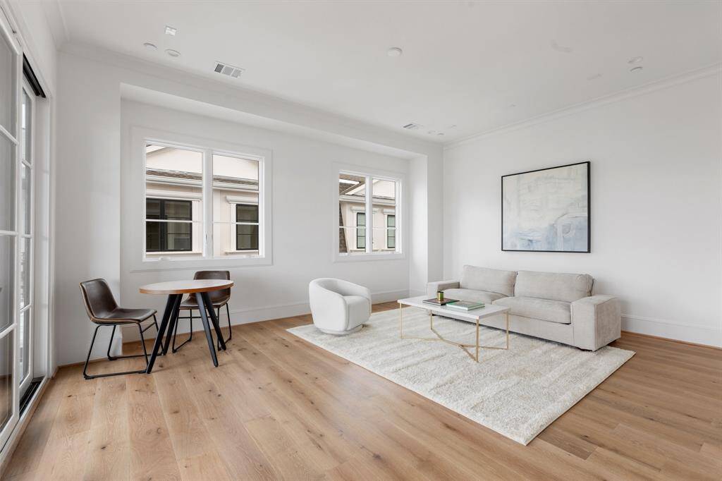 The sliding glass doors to the rooftop terrace encourage indoor/outdoor living, extending the large game room out to the covered patio for year-round enjoyment.