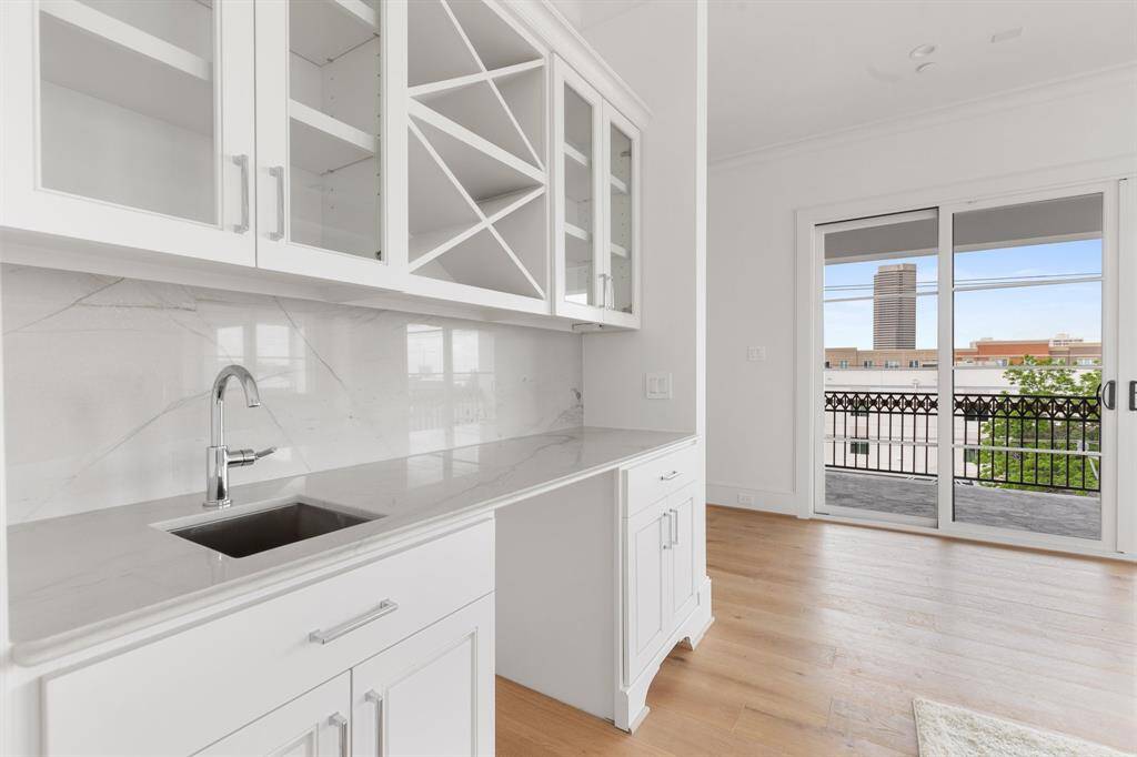The rooftop level is equipped for entertaining with beverage storage, media wiring, and ample natural light.