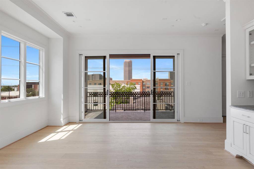 Elegant sliding glass doors blur the line between indoor and outdoor living, connecting the game room with the terrace.