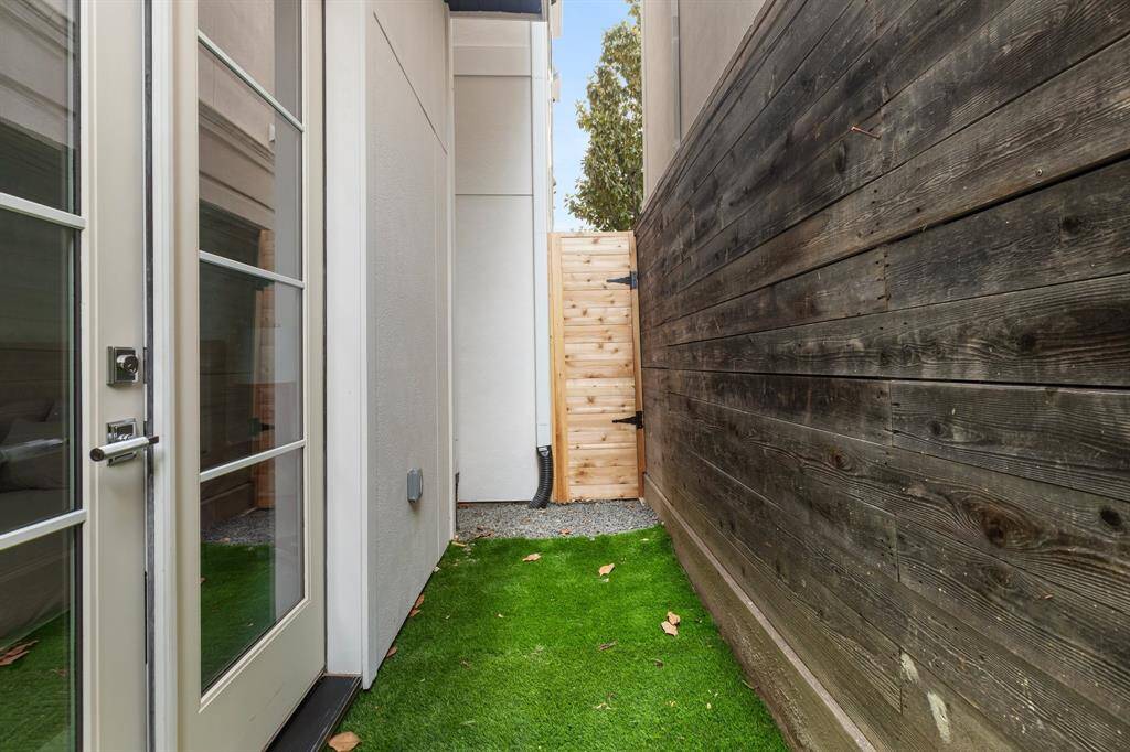 French doors open from the downstairs bedroom to a private grassy yard—perfect for pets.