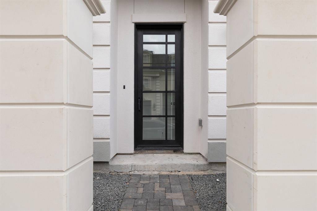 The home's private access gate with keypad entry ensures security and peace of mind, welcoming guests with convenience and control.