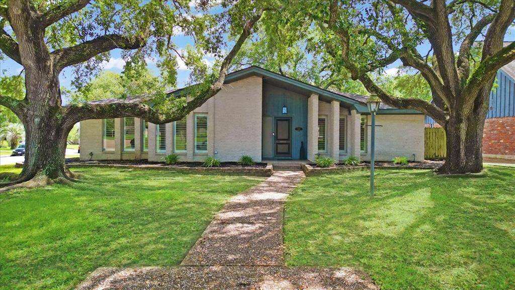 This classic mid-century modern home sits on an oversized corner lot with plenty of yard space.