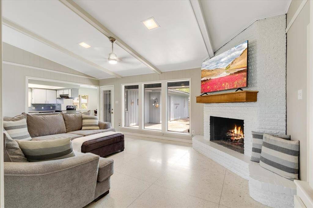 The family room is light and bright- look at all of the windows!  The terrazzo floor is amazing and a classic example of mid-century modern design.