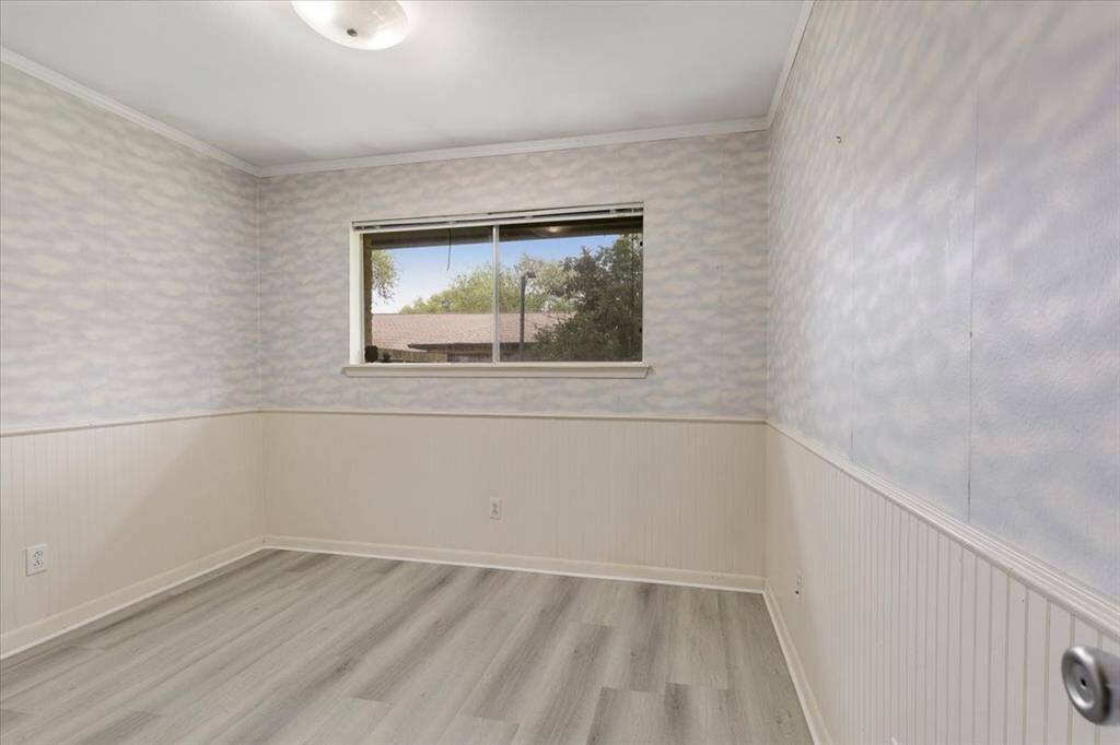 Bedroom 4 also includes new LVP flooring and crown molding.