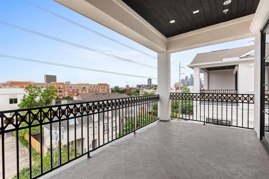 Elegant sliding glass doors blur the line between indoor and outdoor living, connecting the game room with the terrace.