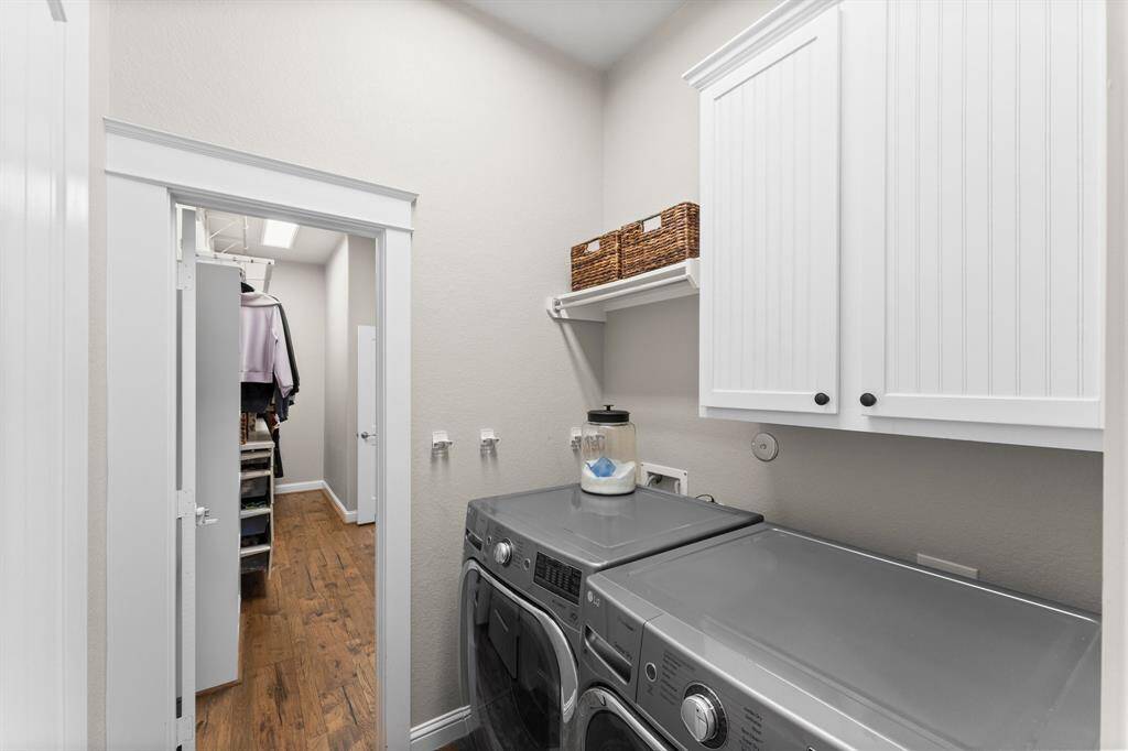 Laundry room with access to the primary closet.