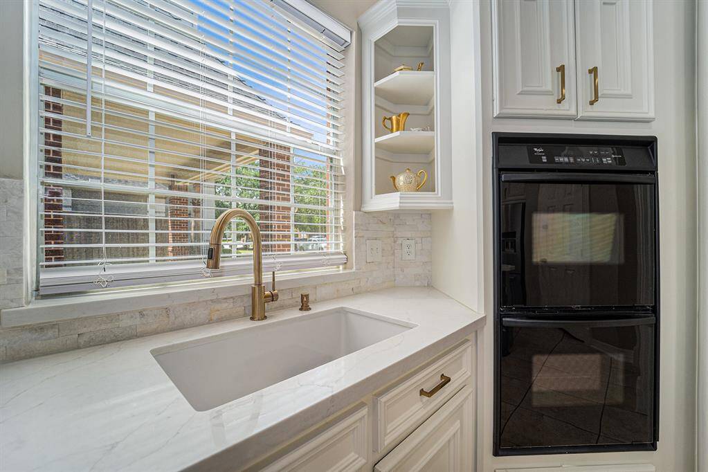 Closer look at the farm-style sink and dual ovens.