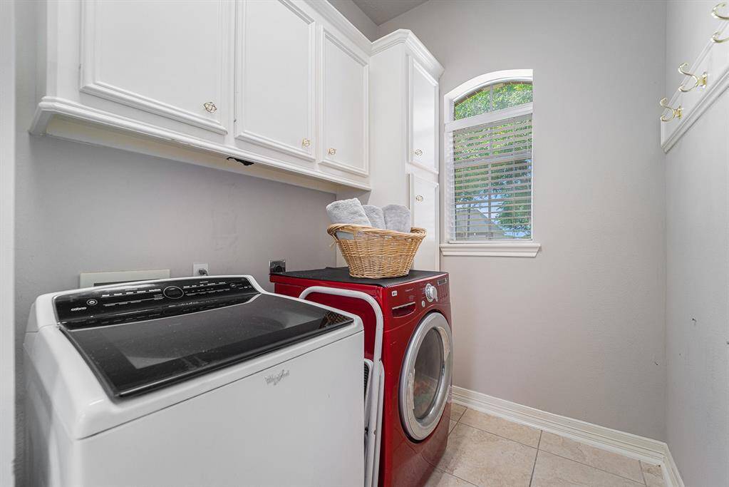 View of the laundry room with extra cabinet space.
