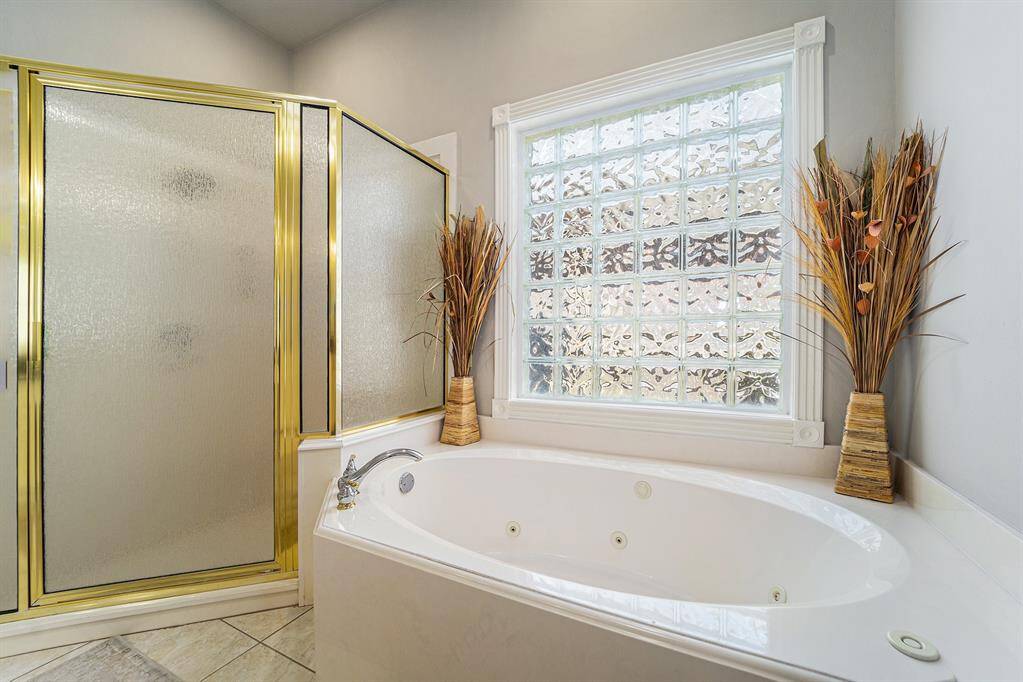 Unwind in this serene spa-like soaking tub and glass-standing shower!