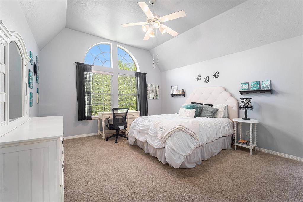 Secondary bedroom with a stunning window that overlooks the front yard.