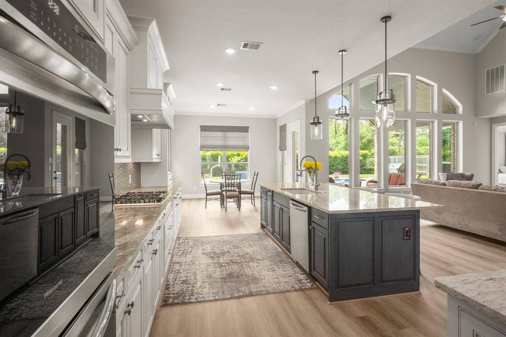 Glass cabinetry and granite counters add a refined touch to this functional area.