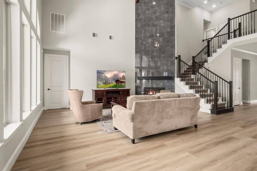 Anchored by a striking electric fireglass fireplace with a floor-to-ceiling tile wall and maple mantel, this space is a showstopper.