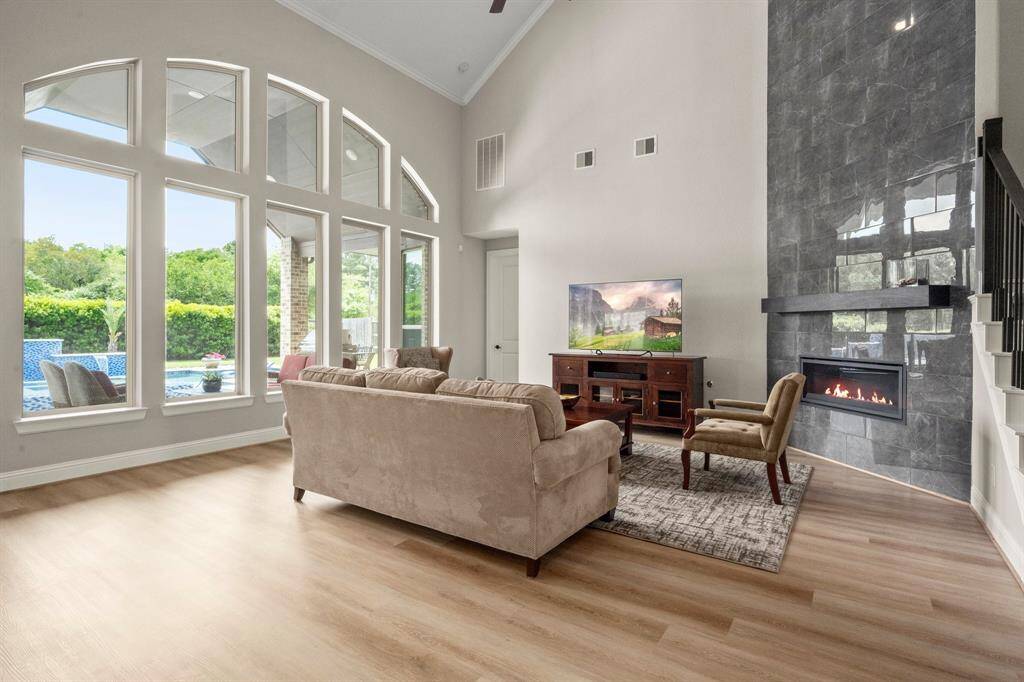 A wall of windows lets in abundant light and frames views of the stunning backyard retreat.