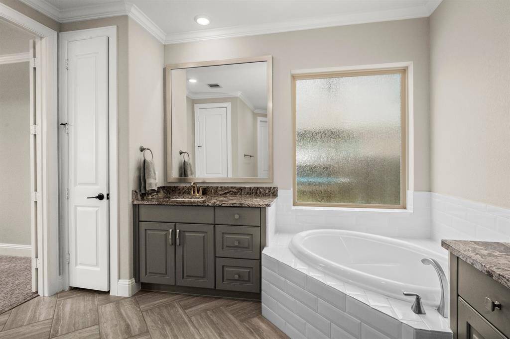 A large soaking tub, walk-in shower, linen closet, complete this retreat.