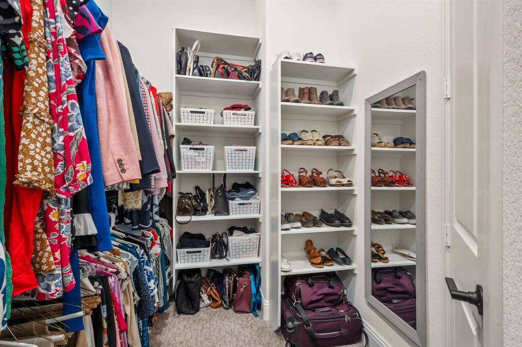Large primary closet with custom shelving.