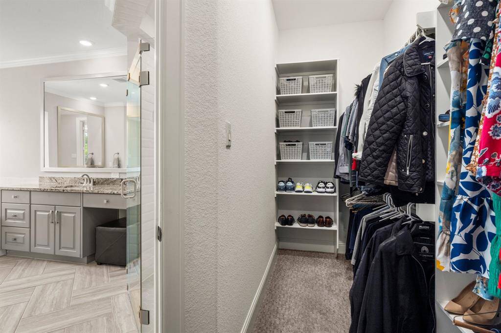 Large primary closet with custom shelving.