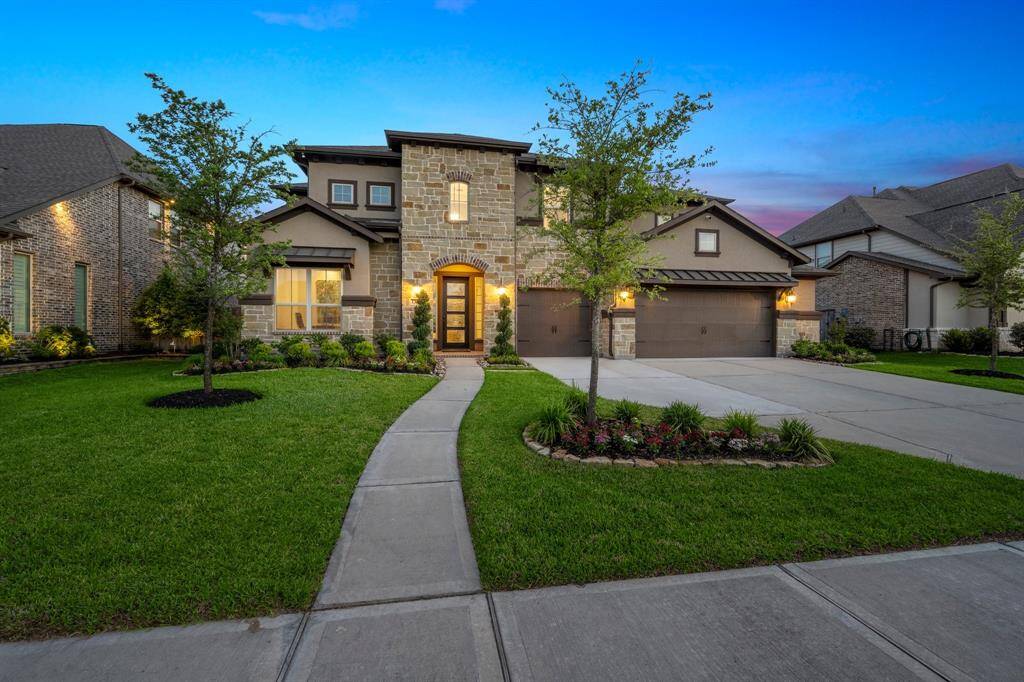 Lush, meticulously maintained landscaping creates stunning curb appeal and a serene welcome every time you arrive.