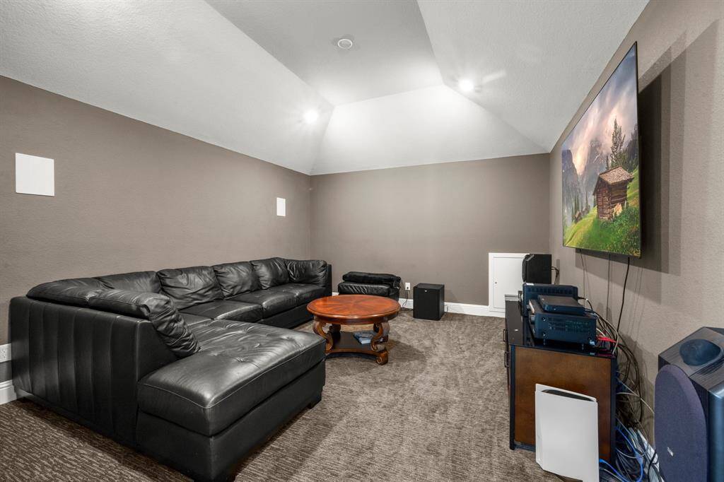 This dedicated media space features surround sound for the ultimate movie night experience.Darker wall tones and soft carpet enhance the theater-like feel.