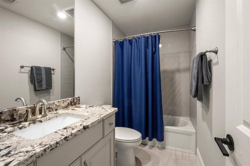 Each bathroom is finished with modern fixtures and neutral tile.