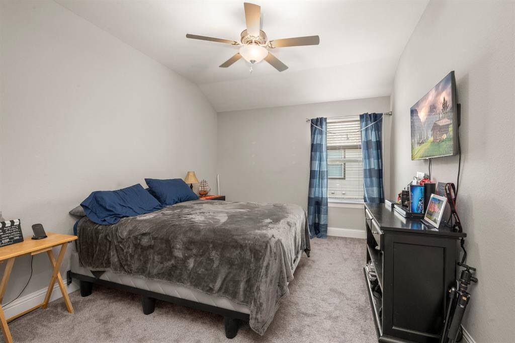 Three well-sized bedrooms upstairs each feature ceiling fans, carpet, and walk-in closets.