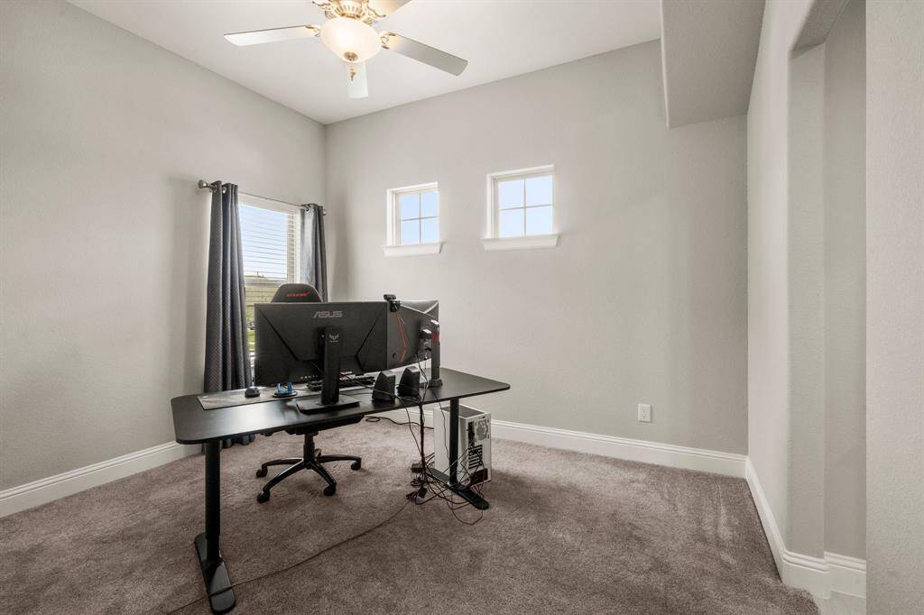 Three well-sized bedrooms upstairs each feature ceiling fans, carpet, and walk-in closets.