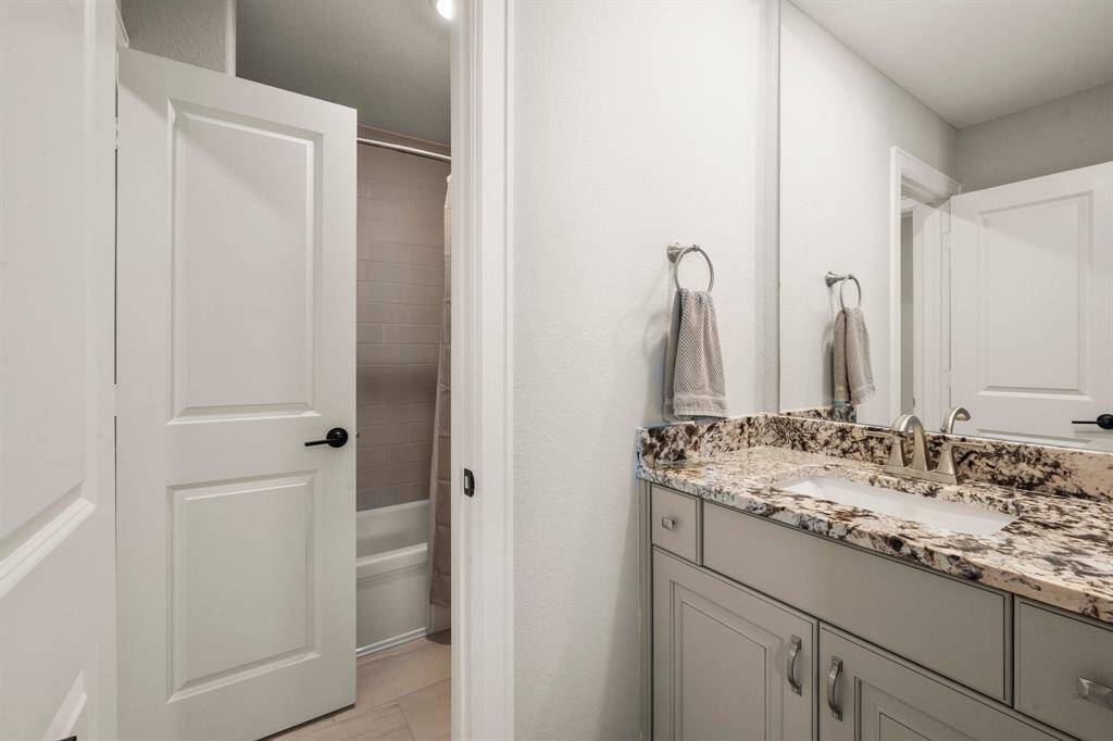 The Jack-and-Jill bath includes double sinks for ease of sharing.